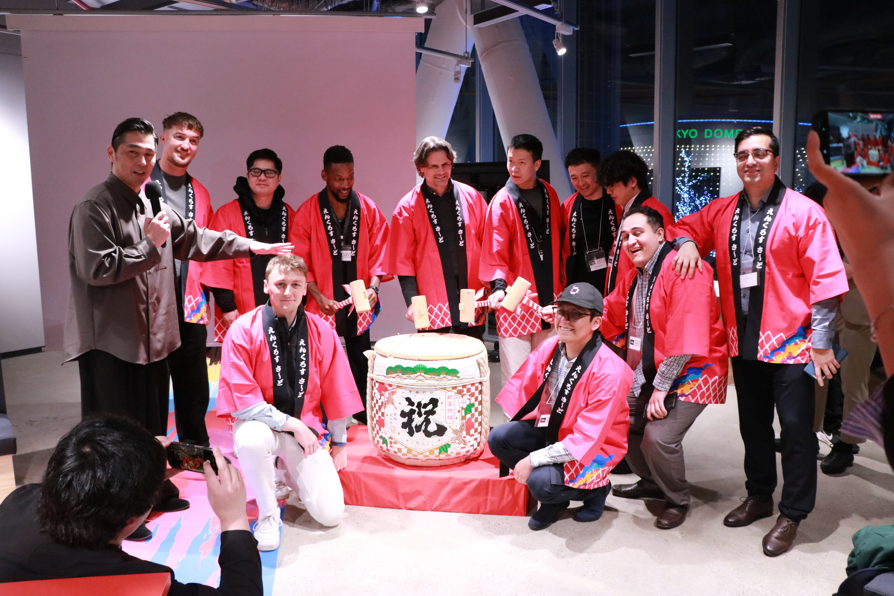 enXross Grand Opening at Tokyo Dome City - team in traditional happi coats around sake barrel