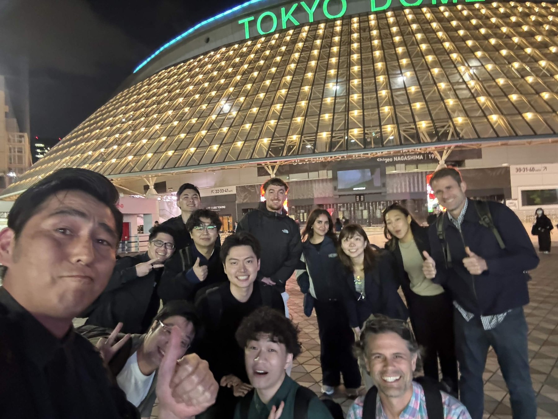 OpenDome cohort outside Tokyo Dome City at night